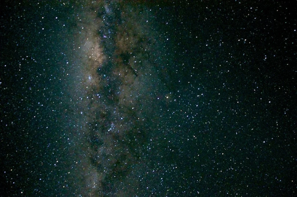 The Milky Way above a dark destination landscape in a real night-sky photograph