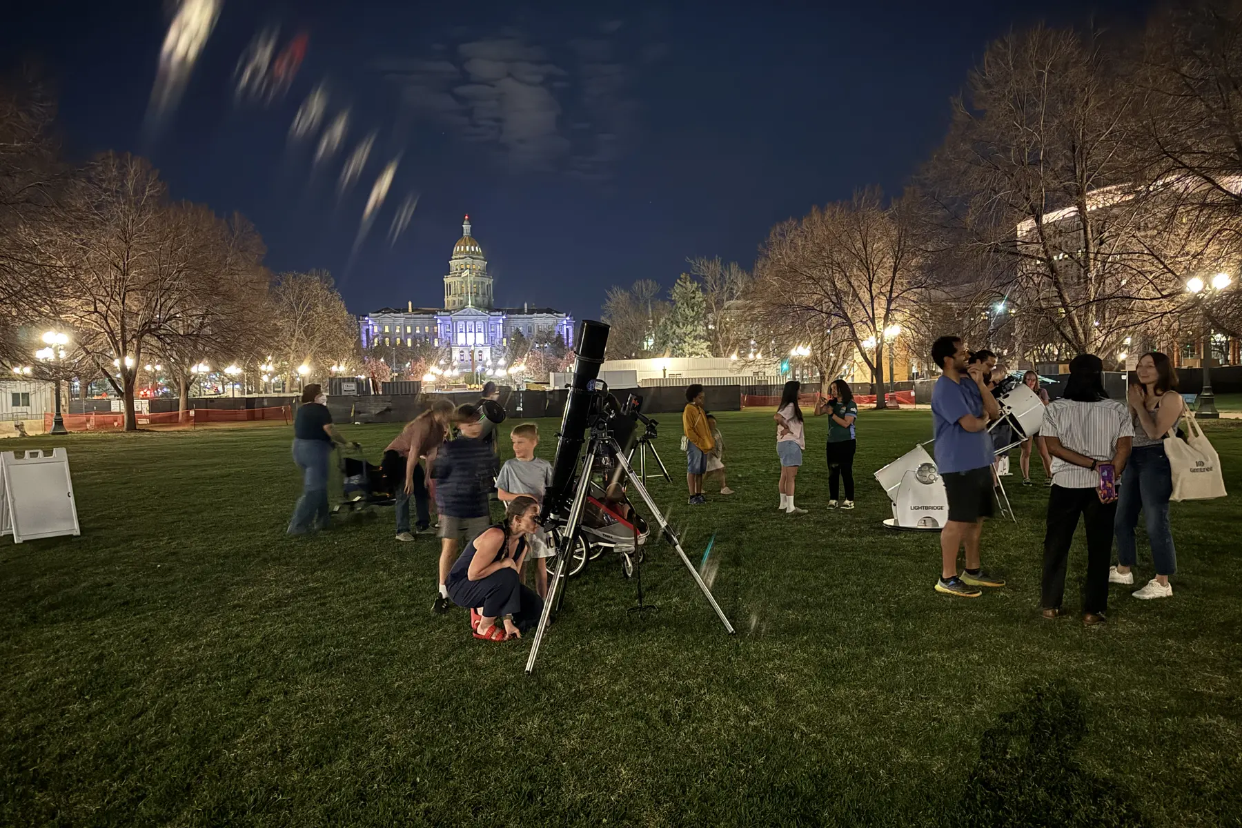 Families and visitors at a real guided telescope program in a public destination space